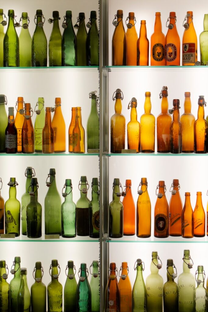 a shelf filled with lots of different colored bottles